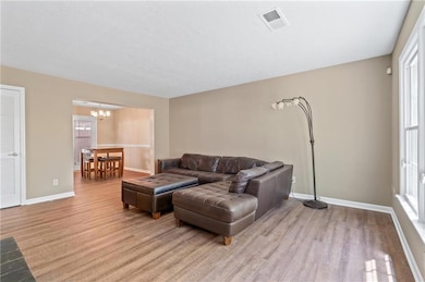 Living room featuring baseboards, light wood-style