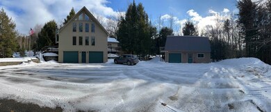 Plenty of paved parking plus THREE garage bays.