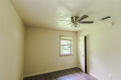 Empty room featuring dark wood finished floors, a