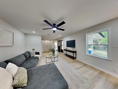 Living area featuring a ceiling fan, visible vents