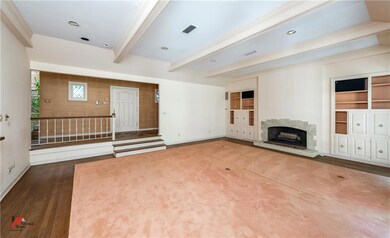 Formal sunken living room with beamed ceiling, bui
