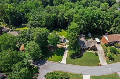 Aerial view of property's location with nearby suburban area