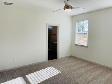 Unfurnished bedroom featuring light colored carpe