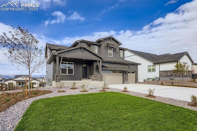 Craftsman inspired home featuring board and batten siding, a front lawn, stone siding, a garage, and driveway