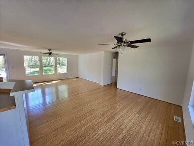 featuring ceiling fan and light bamboo flooring