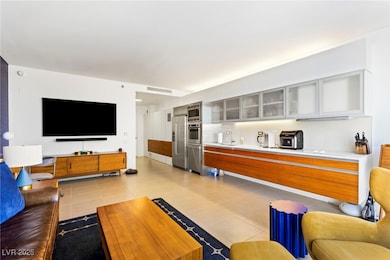 Living area with light tile patterned floors and visible vents