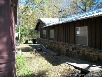 Nice stone and wood siding, metal roof. Detached g