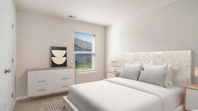 Bedroom featuring light carpet and a closet