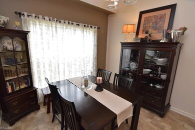 The sunny and inviting dining area has high ceilings.