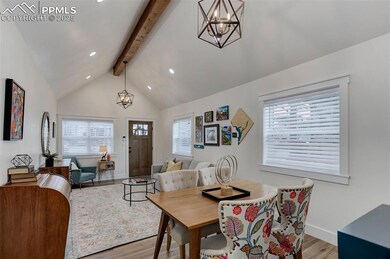 Dining space with lofted ceiling with beams, a cha