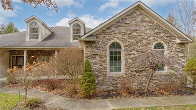 Front of home features impressive custom stone work and professional landscaping