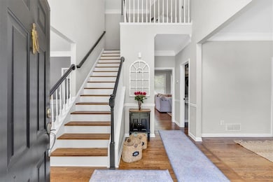 Stairs featuring a towering ceiling, wood finished