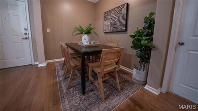 Dining space featuring dark wood finished floors and ornamental molding