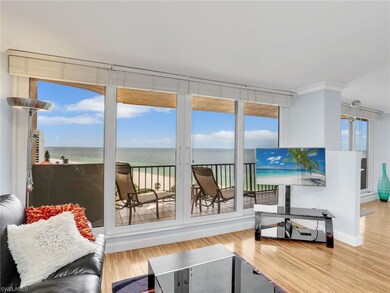 Living area with plenty of natural light, wood finished floors, crown molding, and baseboards