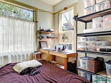 Upstairs, large bedroom with tall windows and lots