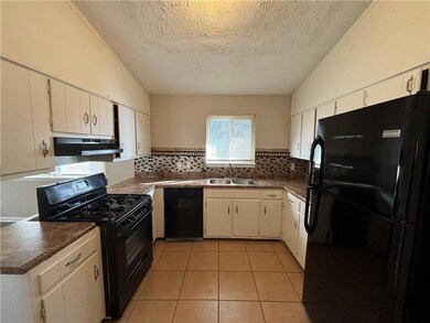 Kitchen with tasteful backsplash, under cabinet ra