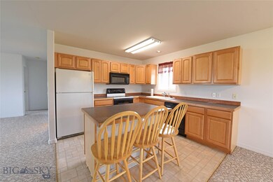 Open kitchen with island and breakfast bar.