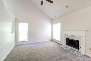 Unfurnished living room with carpet floors, a high