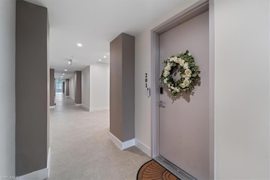 Corridor with recessed lighting and baseboards