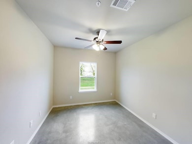 Empty room featuring ceiling fan