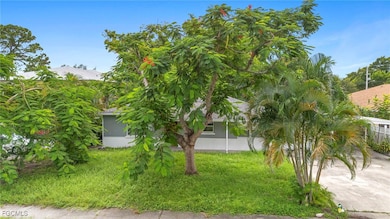 View of grassy yard featuring driveway