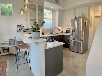 Kitchen with stainless steel appliances, a sink, 