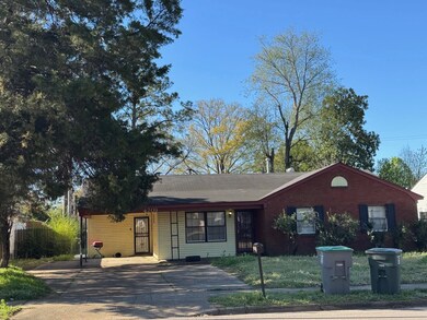 Ranch-style house with brick siding, concrete driv