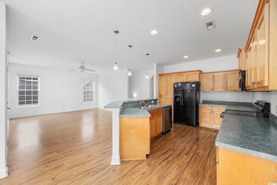 Kitchen featuring visible vents, light wood finish