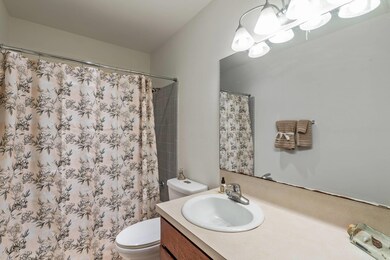 Full bathroom featuring vanity, curtained shower, and a chandelier