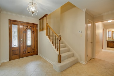 The welcoming entryway features a grand wood front