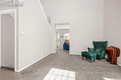 Living area featuring baseboards, visible vents, a