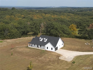 View of subject property featuring a forest