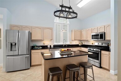 Kitchen has vaulted ceiling, ceramic tile flooring