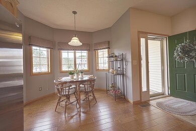 Open design living room/kitchen/dining room area has 9 ft ceilings, granite counter tops, stainless steel appliances, real hardwood flooring, and a gorgeous gas fireplace.