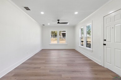 Spare room with crown molding, light hardwood / wo