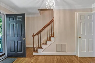 Gracious foyer with coat closet and hardwood floor