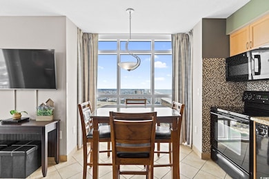 Dining area with light tile patterned flooring
