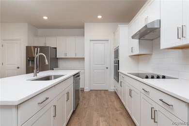 Kitchen with backsplash, wall chimney exhaust hood