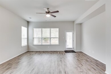 Unfurnished living room with baseboards, light wo