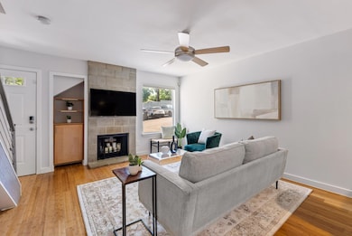Living room featuring light wood-style floors, ce