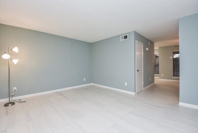 Spacious living room that leads to the half bath,