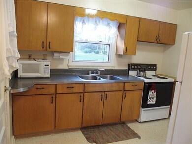 Cute kitchen with door to the covered rear porch a
