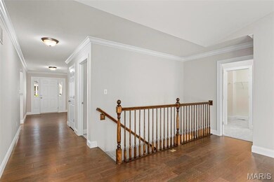 Hallway featuring dark wood-type flooring and ornamental molding