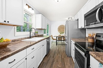 Kitchen featuring sink, dark hardwood / wood-style