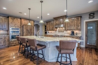 Kitchen features stainless steel appliances, wall 