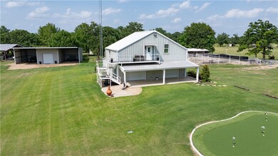 Rear view of property featuring a putting area, dr