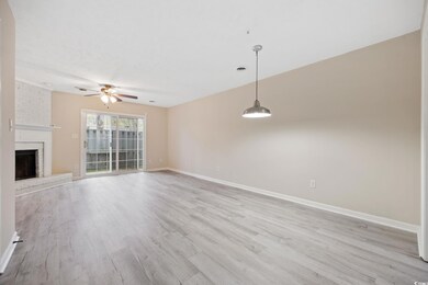 Unfurnished living room with light wood-style flooring, baseboards, visible vents, a ceiling fan, and a fireplace