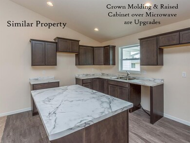 Side view of Kitchen w/ Breakfast Bar.