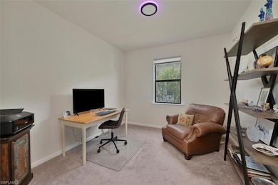 Office space with carpet flooring and baseboards