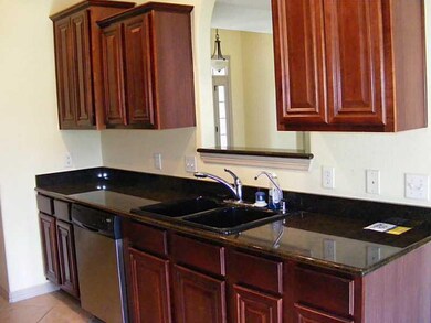 Kitchen. Cherry cabinets with see through to L.R.
